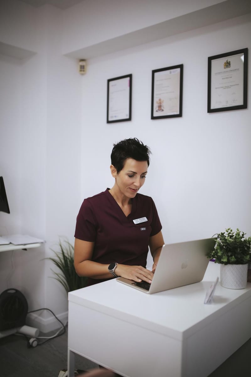 Karen Moseley, nurse prescriber, at the desk at Avismo Aesthetics and Skin