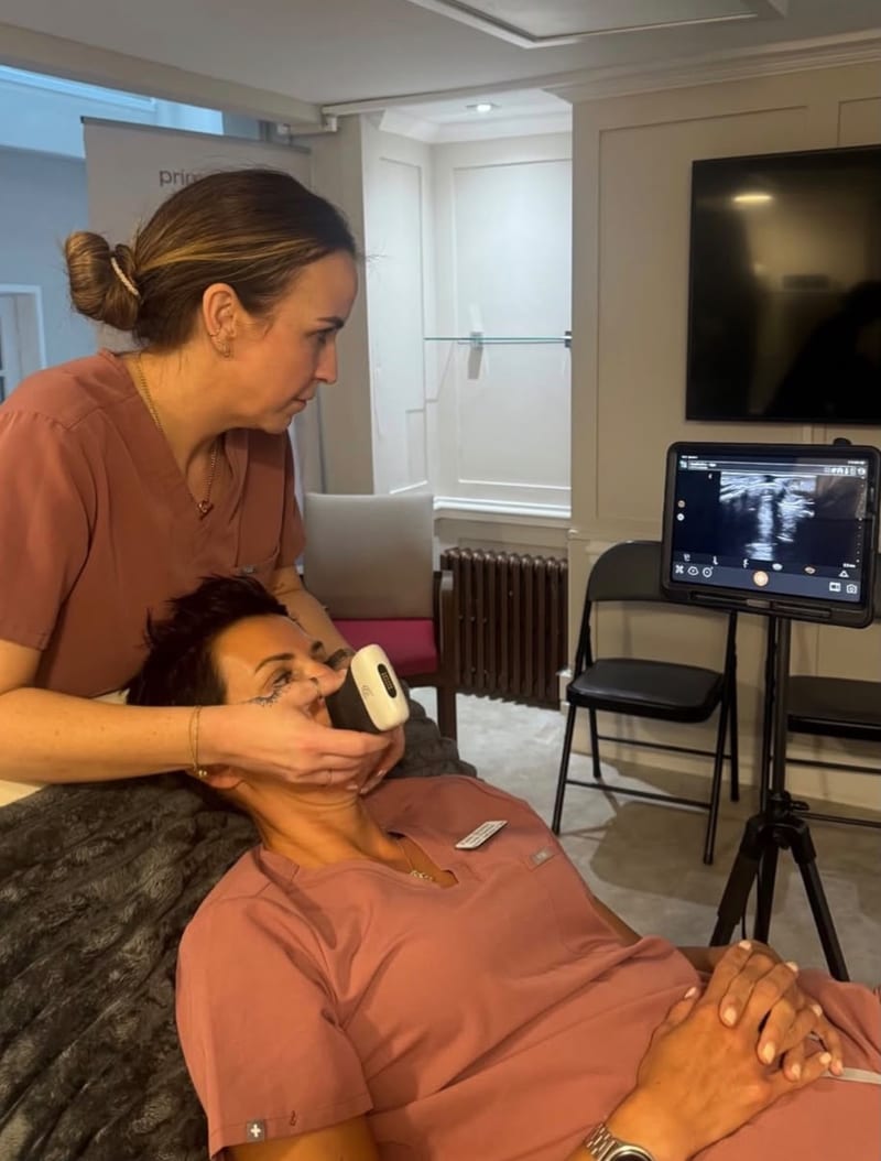 A handheld ultrasound scan of the face, with the tissue beneath the skin shown live on screen